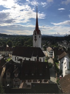 Sunlit church surrounded by old buildings