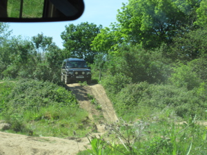 4x4 car at top of steep slope, about to descend