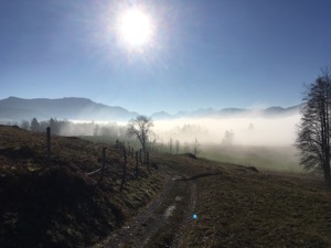 View over mist covered track with mountains in the background