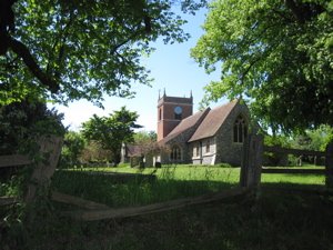 Village Church framed by trees and a fence