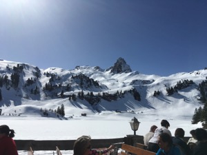 View over sunlight ski slopes and mountains covered in snow