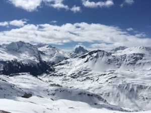 View over snow covered mountains under blue skies