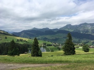 View down green valley, framed by mountains