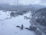 View from gondola of snow covered ski runs and chalets