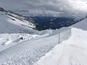 Ski piste with cloud in the valley