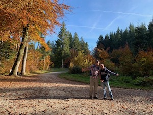 Luis and I standing on a woodland track. Blue skies, beech leaves in autumn colours.