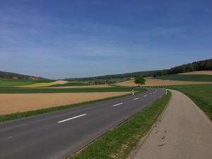 View over rolling hills in bright sunshine.