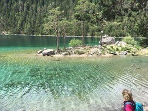 Jules standing in front of the very clear waters of the Blindsee