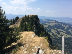 View west from the top of Gross Aubrig. Peak and cliff in foreground, moutains in background.