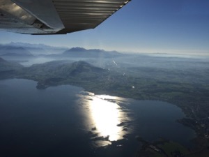 Sunlight reflecting off a lake, viewed from a plane window