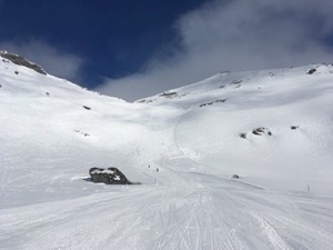 White ski-piste under blue skies