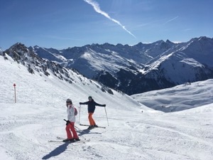 Marcus and Wendy on a ski slope with bright blue skies.