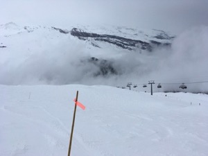 Snow covered mountain, under grey clouds