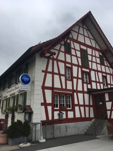 White building with red painted tudor-style beams