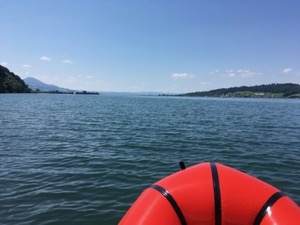 View over the water of the Zurisee, under a blue sky