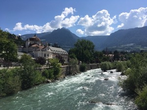 Town hall in Merano and the river in bright sunshine.