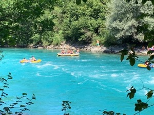 Turquoise water of Aare with people rafting.