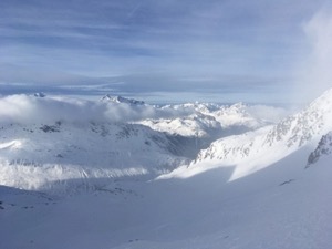 Snow covered mountains under blue skies.