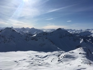 Blue skies over snow covered mountains.