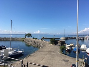 Small boats harbour in Neuchatel, under blue skies.