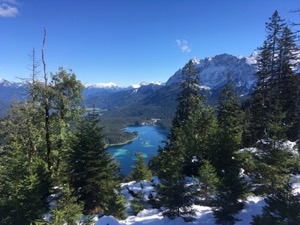 View down over the crystal clear Eibsee, framed by mountains and trees