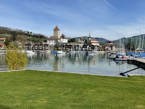 Spiez schloss viewed across the harbour. Small boats in the foreground