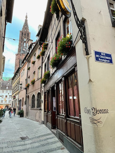 Street in old town Strasbourg with the cathedral in the background.