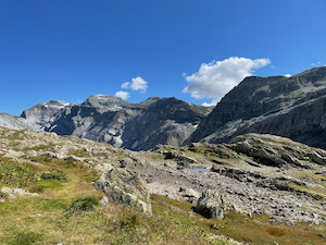 View from the top of the Panix pass looking back down towards the Glarus side. Fairly barren high
                 alpine landscape, mountains in the background.