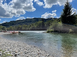 River Aare, in sunshine, some inflatable boats just coming into view.