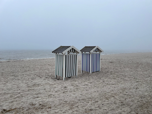 Beach huts in the fog.