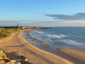 Tynemouth beach in early morning sunshine.