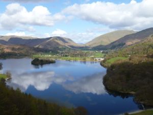 View over lake to Grasmere, with clouds reflected in water