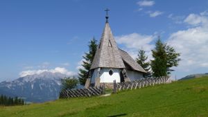 Small chapel with mountains in background