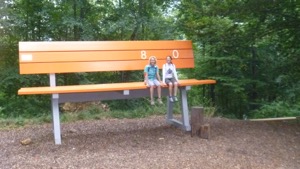 Jules and Diane sitting on an oversized bench