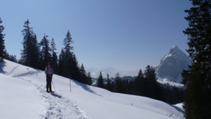 George standing on a snow shoe track, with the Grosser Mythen in the background