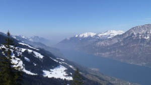 View over the Walensee, with snow covered mountains in the foreground and background