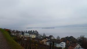 View over cloudy lake towards islands in fog